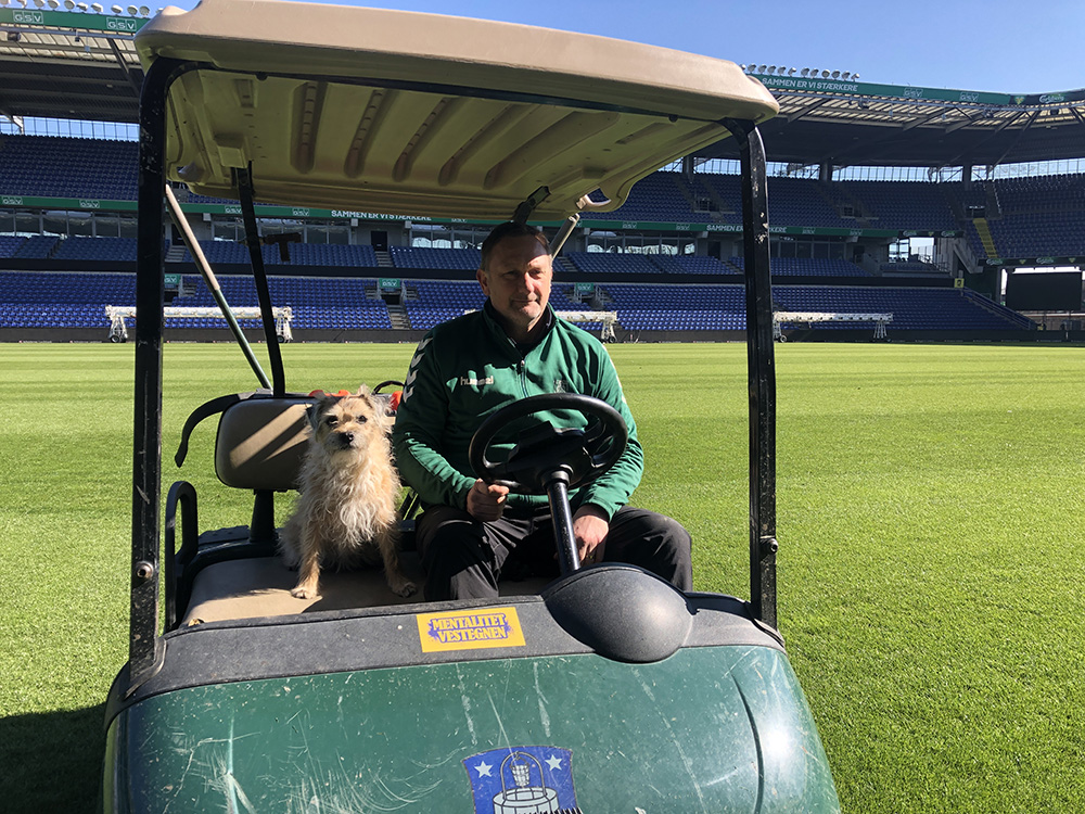 Chris Hague from Brondby FF with dog in utility cart